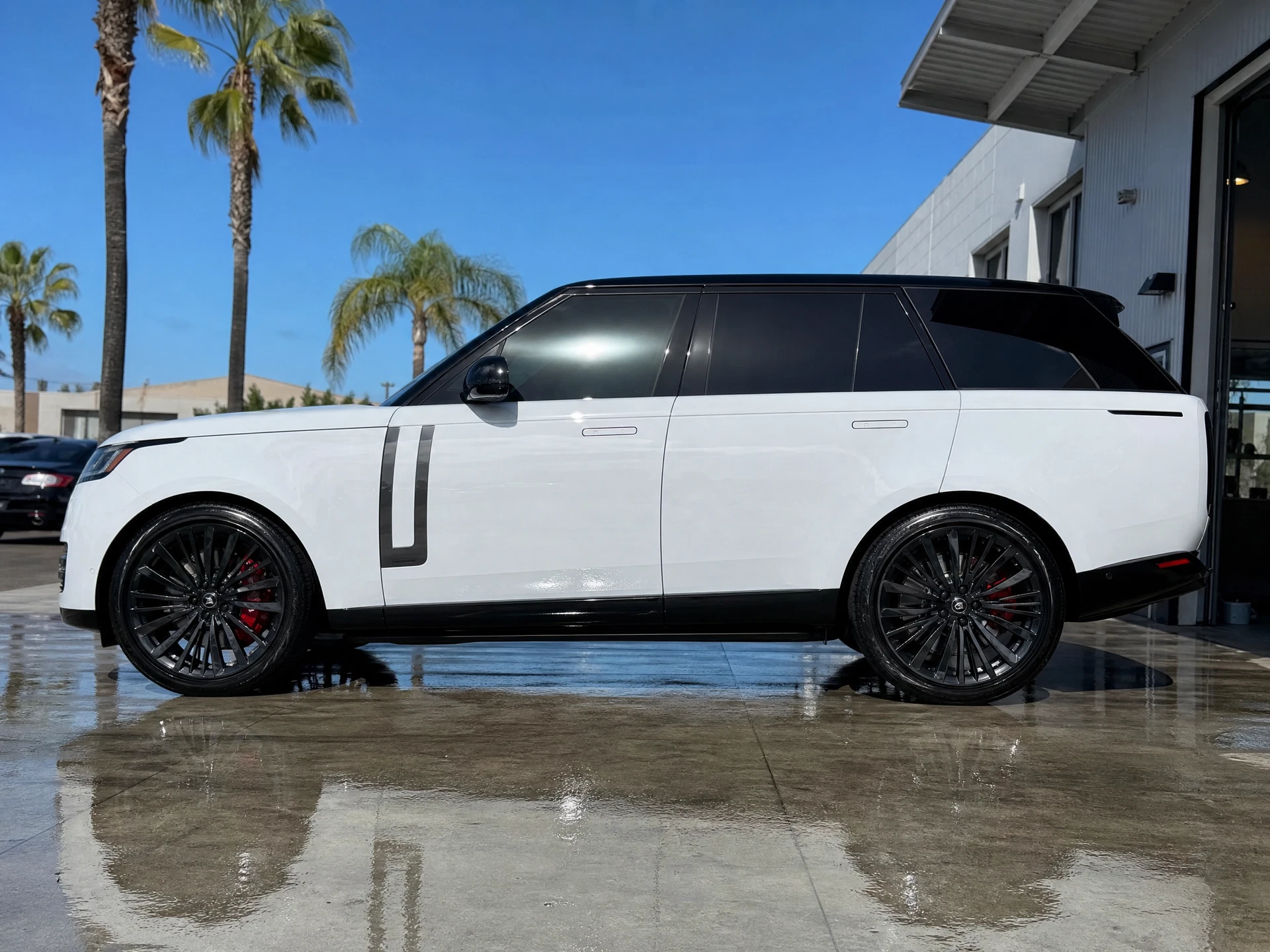 Glossy white SUV after exterior surface care