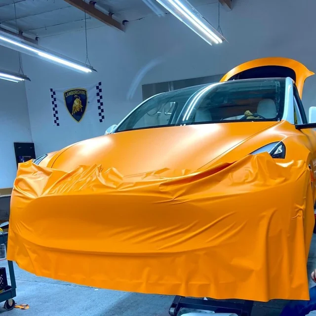 Technician working on a vehicle at Enhanced Automotive
