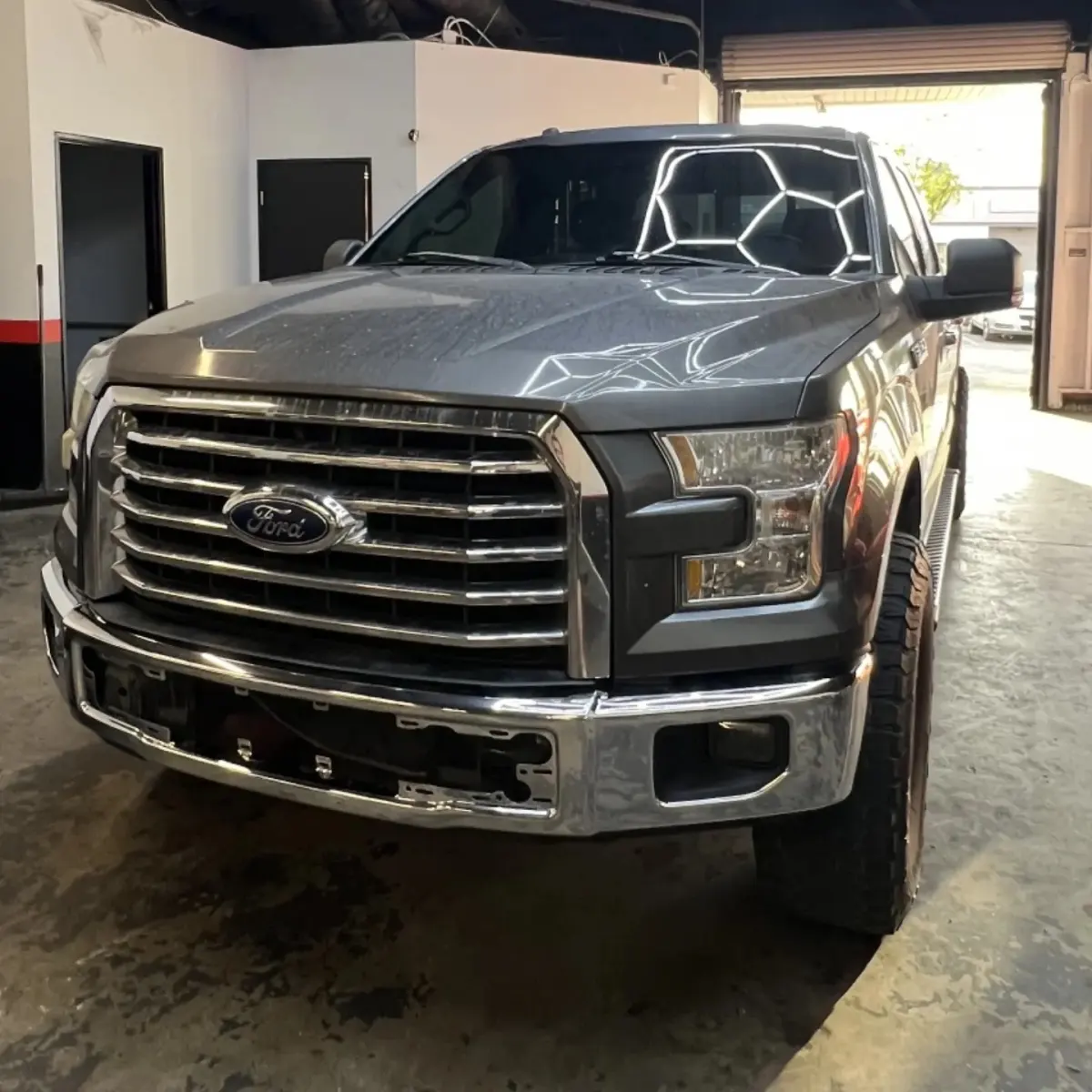 Ford F-150 pickup at the Enhanced Automotive shop with its original chrome front bumper