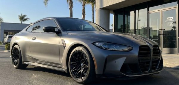 Matte gray BMW M4 with professional vinyl wrap installed at San Diego automotive shop