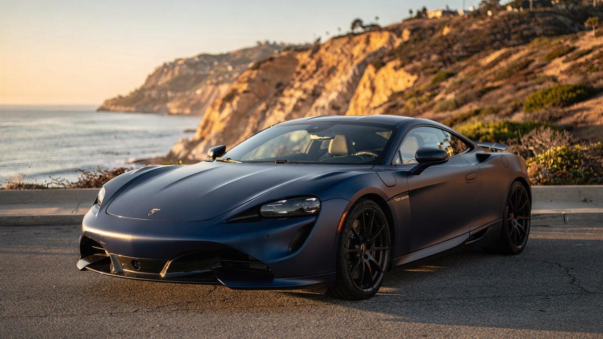 Matte blue vinyl wrapped car at San Diego coastal overlook showing UV exposure conditions